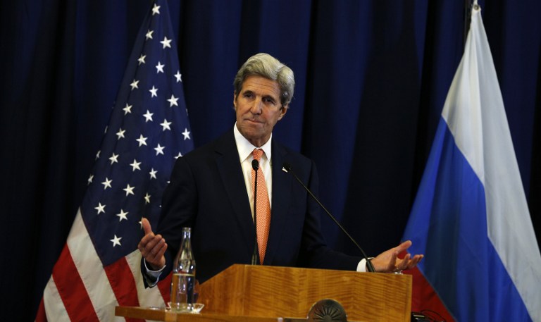 US Secretary of State John Kerry gestures during a press conference with Russian Foreign Minister Sergei Lavrov following their meeting in Geneva where they discussed the crisis in Syria