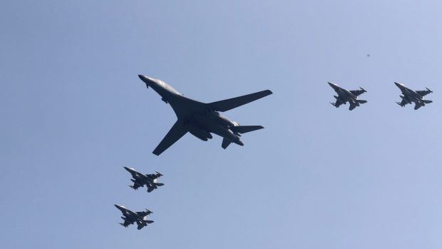 US B-1 bomber centre flies over Osan Air Base accompanied by jet fighters