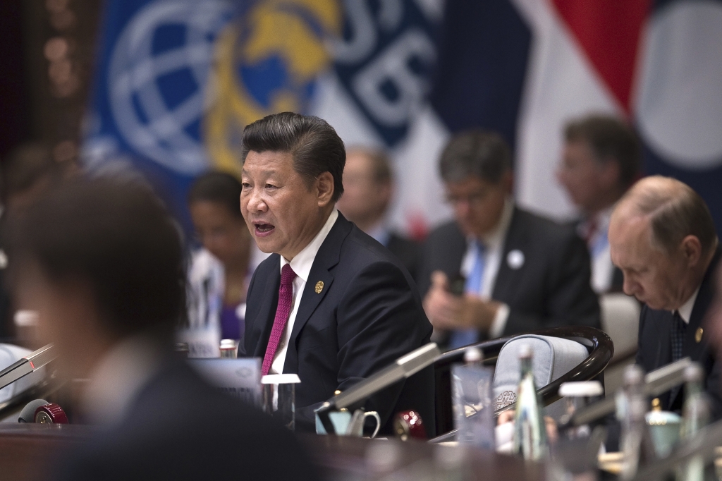 Chinese President Xi Jinping cetner makes a speech during the opening ceremony of the G20 leaders summit as U.S. President Barack Obama left and Russia's President Vladimir Putin right listen in Hangzhou in China's eastern Zhejiang province Sunda