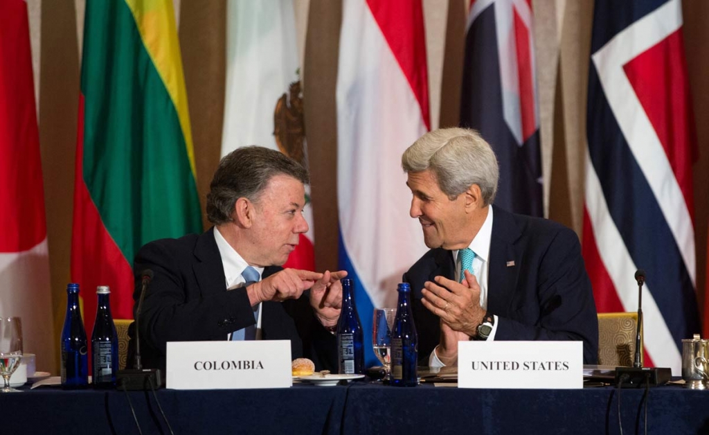 U.S. Secretary of State John Kerry right talks with President Juan Manuel Santos of Colombia during the Global Demining Initiative for Colombia meeting Sunday Sept. 18 2016 in New York