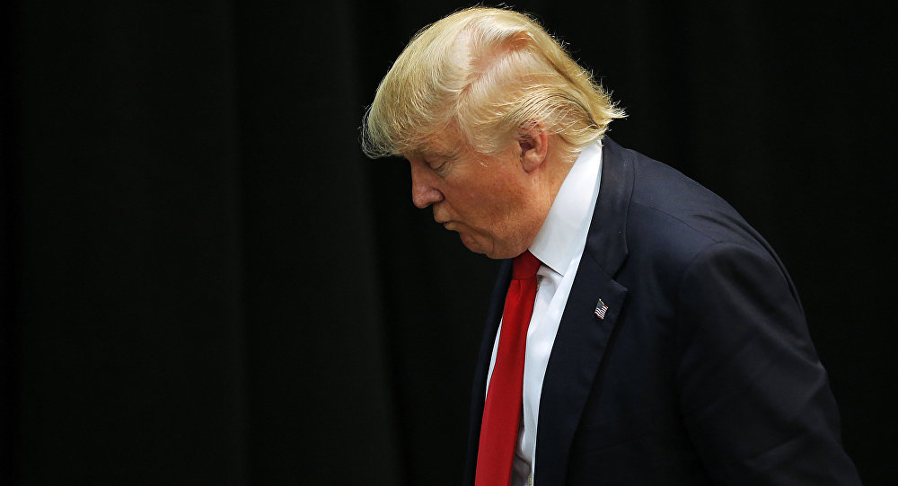 US Republican presidential candidate Donald Trump looks down as he leaves a campaign event in Concord North Carolina