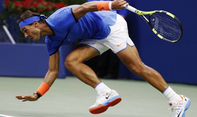 Rafael Nadal of Spain struggles to maintain his footing during play against Lucas Pouille of France during the fourth round of the U.S. Open tennis tournament Sunday Sept. 4 2016 in New York