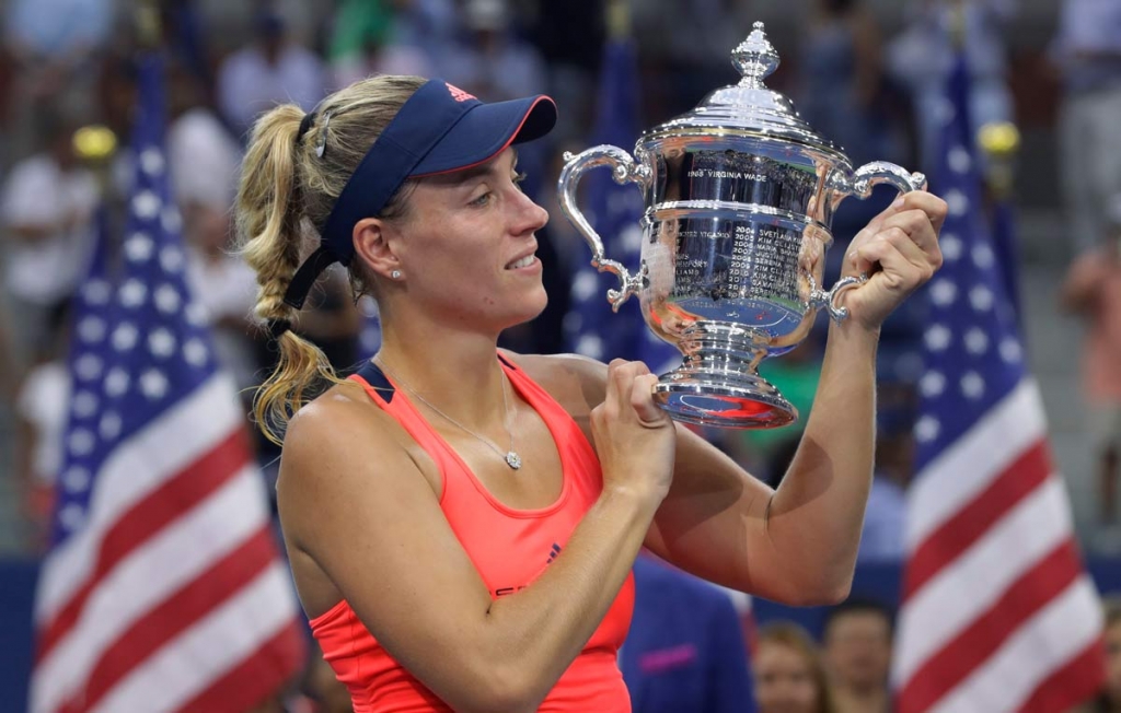 Angelique Kerber of Germany holds up the championship trophy after beating Karolina Pliskova of the Czech Republic to win the women's singles final of the U.S. Open tennis tournament Saturday Sept. 10 2016 in New York