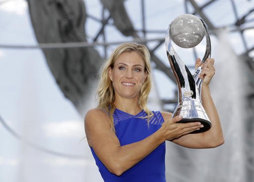 Angelique Kerber of Germany poses with the WTA No. 1 trophy after winning the women's single final at the U.S. Open tennis tournament Sunday Sept. 11 2016 in New York