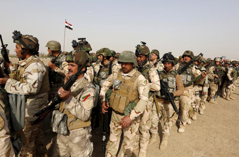 Iraqi security forces wait for vehicles travelling to Mosul to fight against militants of Islamic State at an Iraqi army base in Camp Taji in Baghdad Iraq