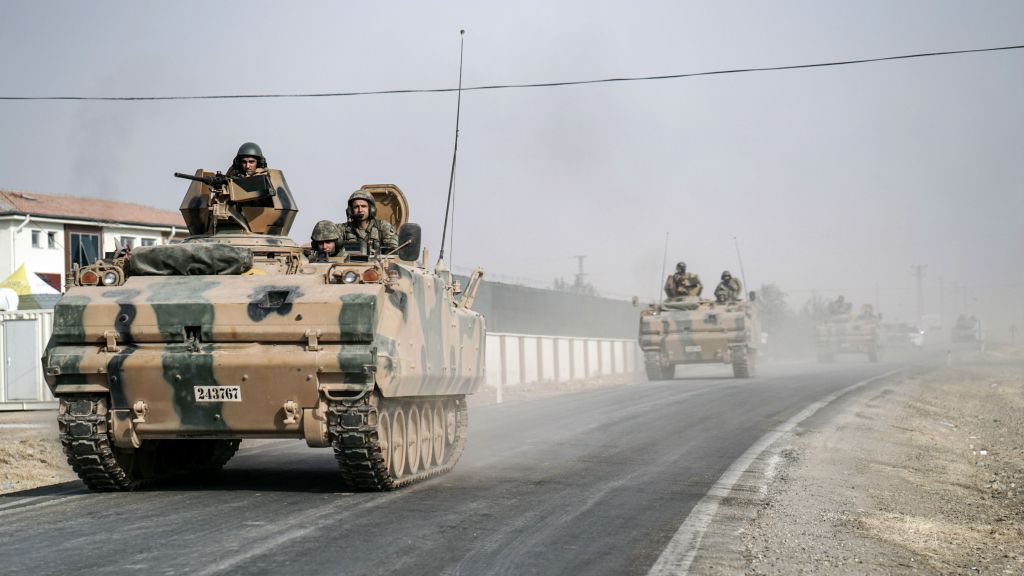 Turkish army tanks and armored personnel carriers move toward the Syrian border in Karkamis Turkey