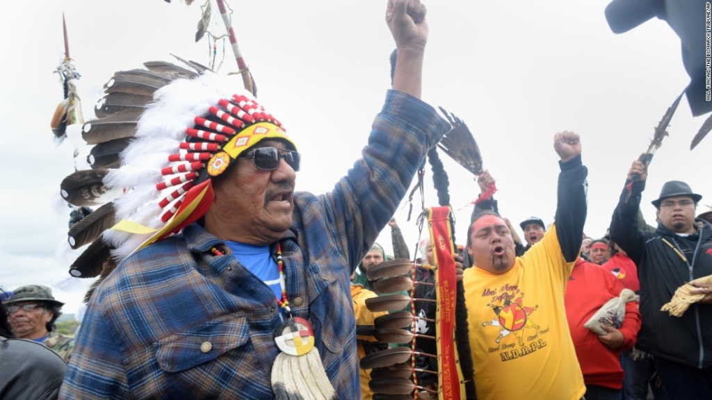 JR American Horse raises his fist with others while leading a march to the Dakota Access Pipeline site in southern Morton County North Dakota. Several hundred protesters marched about a mile up Highway 1806 on Friday September 9 to the area of the pipe