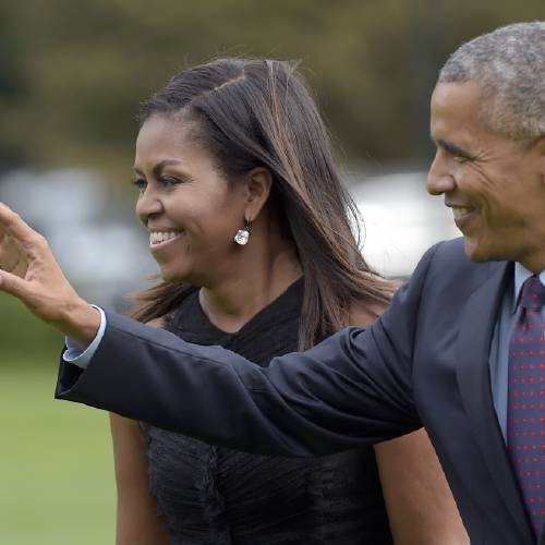 Obama with first lady Michelle Obama waves as they walk from Marine One on the South Lawn of the White House in Washington Wednesday Sept. 21 2016. The Obama's were returning from New York where the president addressed