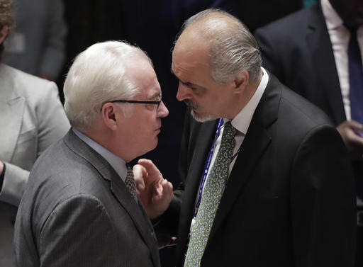 Syria's permanent representative to the United Nations Bashar Jaafari right talks with Russia's U.N. Ambassador Vitaly Churkin before the start of a Security Council meeting Wednesday Sept. 21 2016 at U.N. headquarters