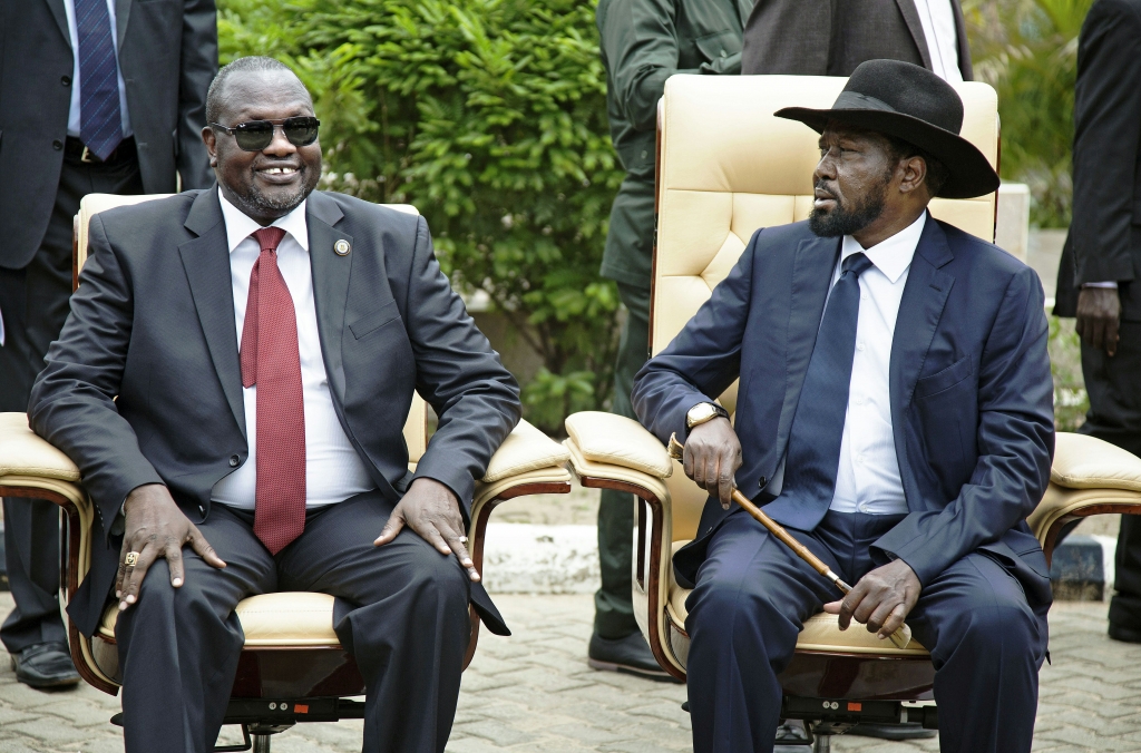 First Vice President of South Sudan and former rebel leader Riek Machar, and President Salva Kiir, sit for an official