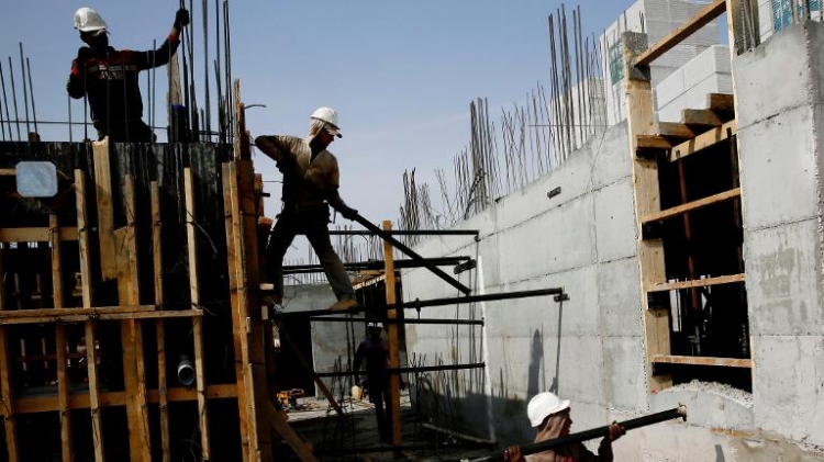 Palestinian laborers work on a construction site in Ramat Shlomo a Jewish settlement in the mainly Palestinian eastern sector of Jerusalem