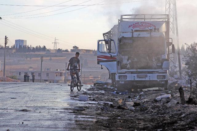 The Latest: UN suspends Syria convoys after aid trucks hit