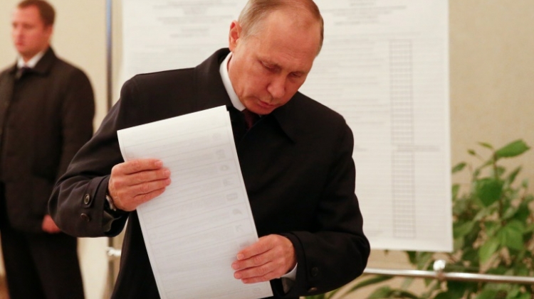 Russian President Vladimir Putin casts his ballot during parliamentary elections in Moscow