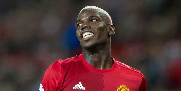 Manchester United's Paul Pogba smiles during the English Premier League soccer match between Manchester United and Southampton at Old Trafford