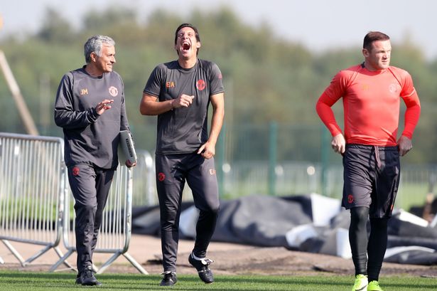 Manchester United manager Jose Mourinho shares a joke with Emilio Alvarez as captain Wayne Rooney looks on during a training session at Aon Training Complex