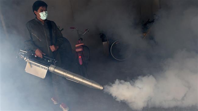 A municipal worker fumigates a residential area against mosquitoes as a preventive measure in the Thai capital Bangkok