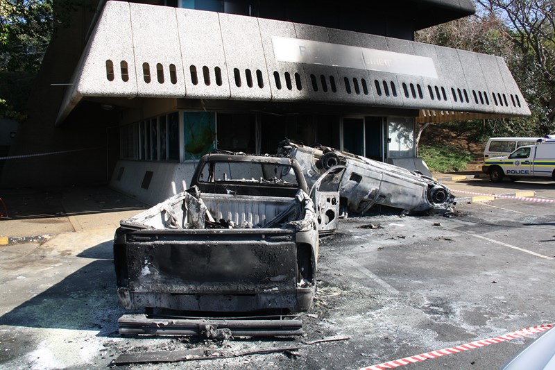 Vehicles overturned and burnt at risk management building in 2015