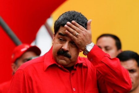 Venezuela's President Nicolas Maduro wipes his face while he speaks during a pro-government rally in Caracas Venezuela