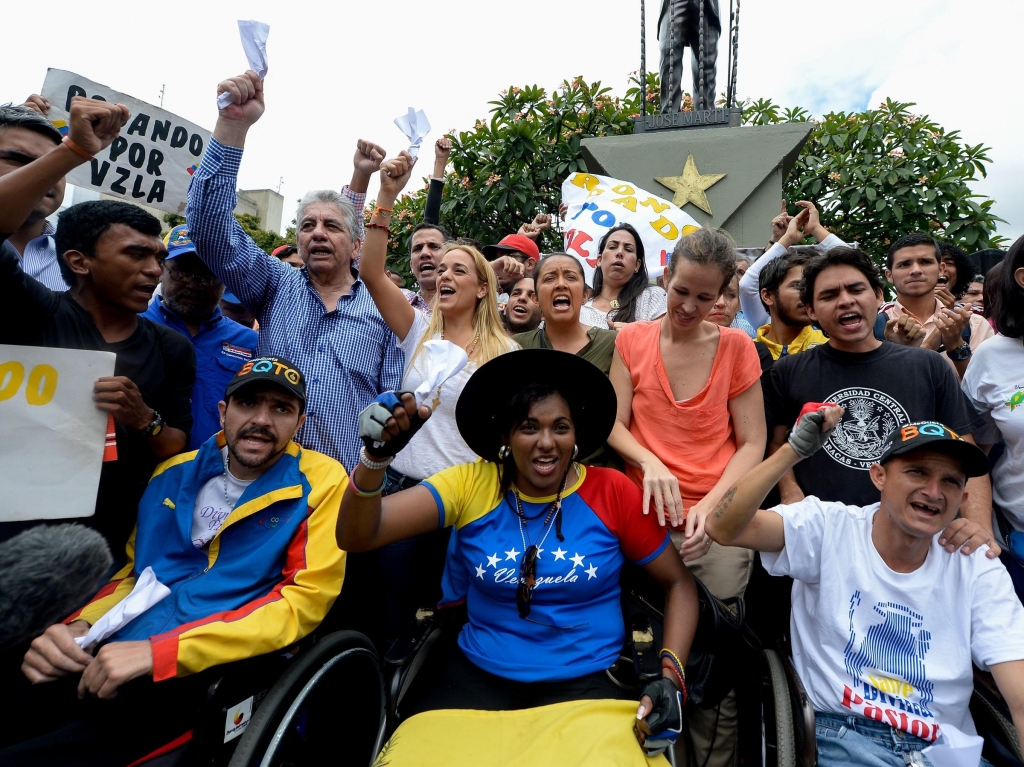 Lilian Tintori second row center in white blouse the wife of jailed opposition leader Leopoldo Lopez takes part in a demonstration in Caracas on Aug. 31. Venezuelan President Nicolas Maduro vowed Tuesday to jail opposition leaders if they incite viole