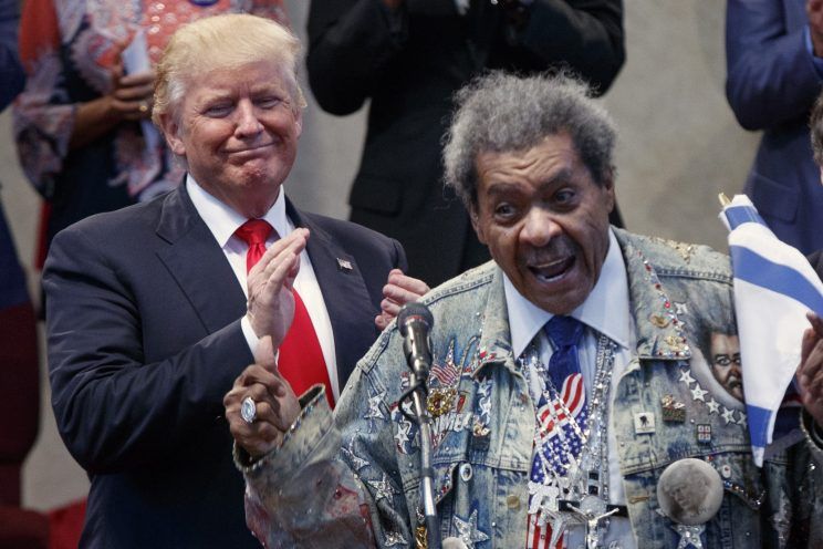 Donald Trump applauds as he is introduced by boxing promoter Don King in Cleveland Ohio