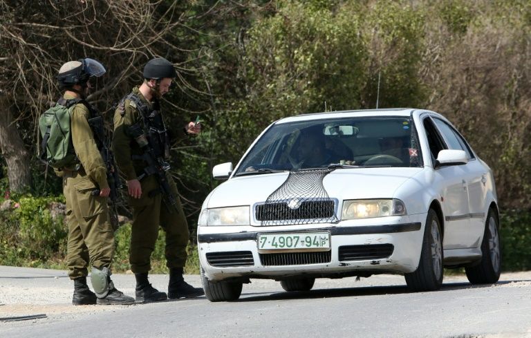 Israeli border guards check a driver near the Palestinian town of Qalqilya in the occupied West BankMore