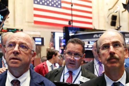 Traders work on the floor of the NYSE