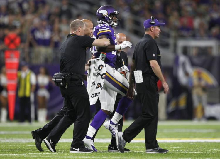 Minnesota Vikings running back Adrian Peterson was carried off the field with a right knee injury during Sunday's game against the Packers