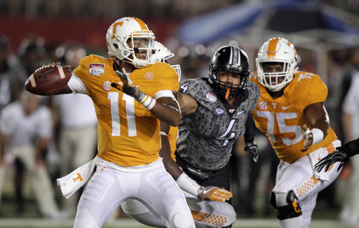 Tennessee quarterback Joshua Dobbs passes as Virginia Tech defensive end Ken Ekanem gets past Tennessee offensive lineman Jashon Robertson during the first half of a football game at Bristol Motor Speedway on Saturday Sept. 10 2016 in Bri