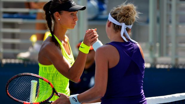 Vitalia Diatchenko of Russia shakes hands with Timea Bacsinszky of Switzerland after their first round Women's Singles match