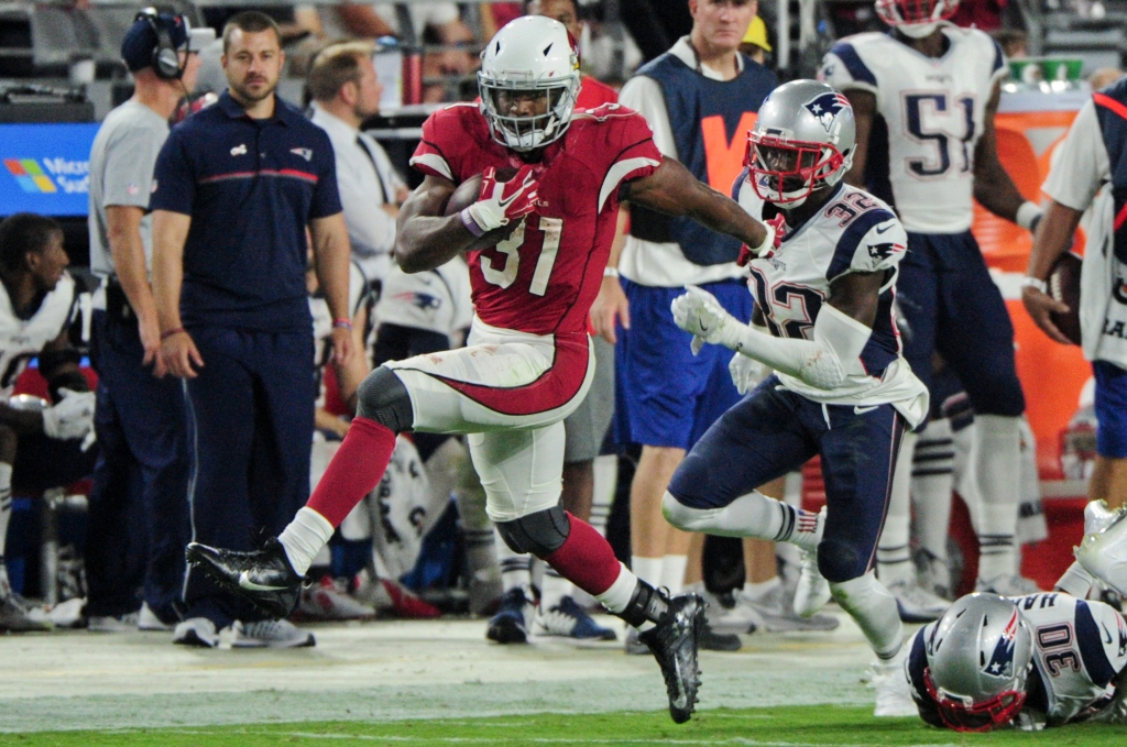 Sep 11 2016 Glendale AZ USA Arizona Cardinals running back David Johnson fends off New England Patriots free safety Devin Mc Courty during the second half at University of Phoenix Stadium. Mandatory Credit Matt Kartozian-USA TODAY Sports