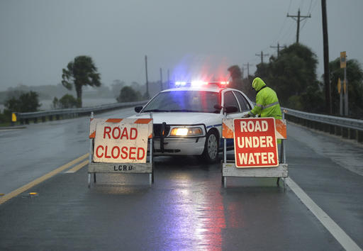 Police block the road entering Cedar Key Fla. as Hurricane Hermine nears the Florida coast Thursday Sept. 1 2016. Hurricane Hermine gained new strength Thursday evening and roared ever closer to Florida's Gulf Coast where rough surf began smash