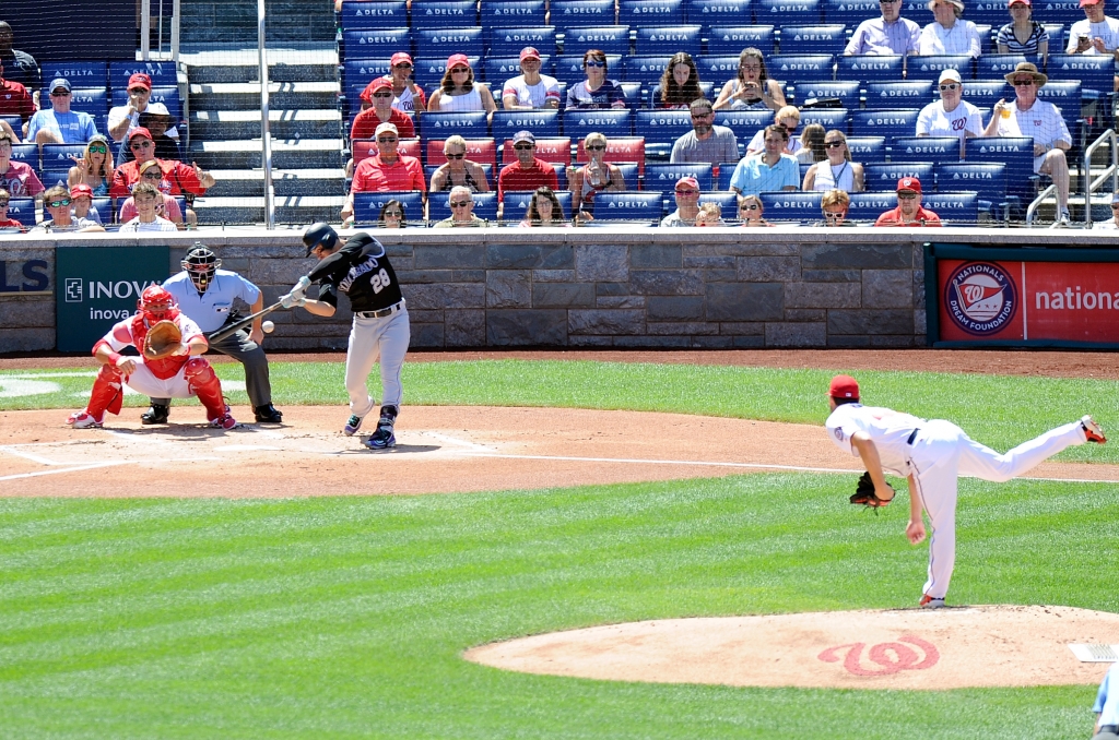 WASHINGTON DC- AUGUST 28 Nolan Arenado #28 of the Colorado Rockies drives in a run with a single in the first inning against the Washington Nationals at Nationals Park