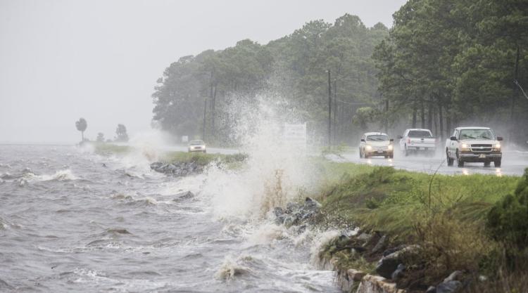 Waters along the Gulf Coast batter a stretch of US 98 in Eastpoint Fla