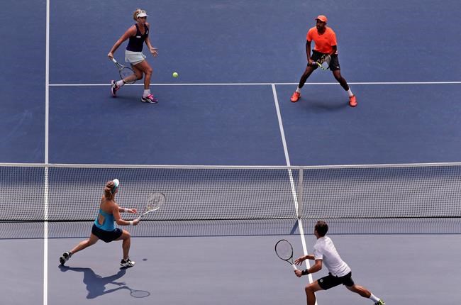 Coco Vandeweghe of the United States top left returns a shot alongside partner Rajeev Ram of the United States to Laura Siegemund of Germany and Mate Pavic of Croatia during the mixed doubles semifinals of the U.S. Open tennis tournament Friday