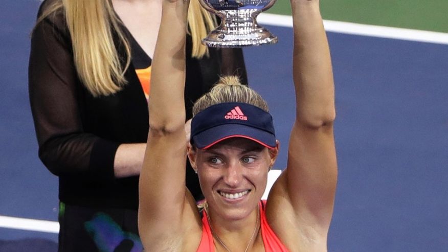 Angelique Kerber of Germany holds the champions trophy after defeating Karolina Pliskova of the Czech Republic during the women's singles final of the U.S. Open tennis tournament Saturday Sept. 10 2016 in New York