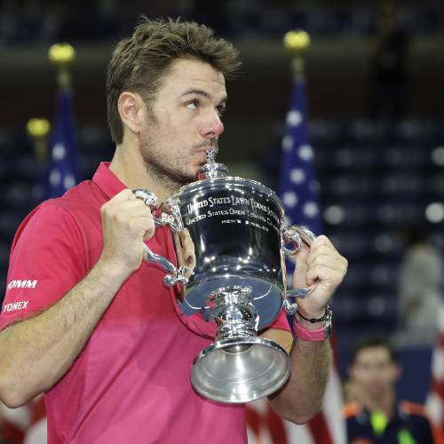 Switzerland kisses the championship trophy after beating Novak Djokovic of Serbia to win the men's singles final of the U.S. Open tennis tournament Sunday Sept. 11 2016 in New York