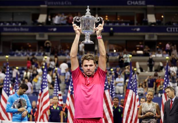 Stan Wawrinka of Switzerland holds up the championship trophy after beating Novak Djokovic of Serbia to win the men's singles final of the U.S. Open tennis tournament Sunday Sept. 11 2016 in New York