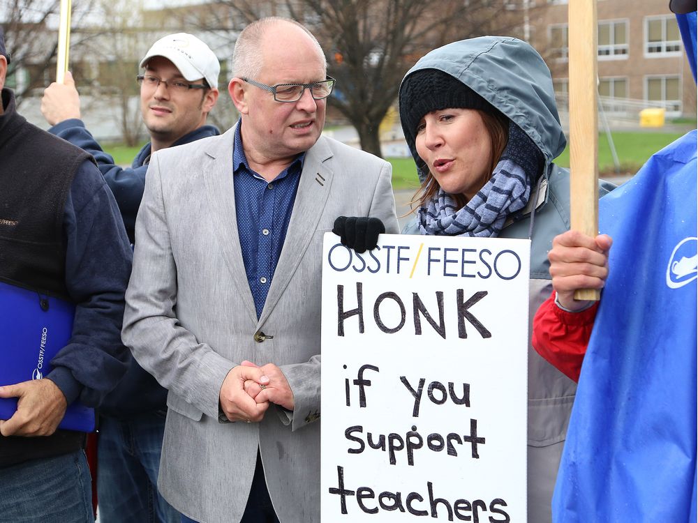 Sid Ryan left president of the Ontario Federation of Labour talks to Camille Dupuis at the teachers&#039 picket line at Lasalle Secondary School in Sudbury Ont. on Tuesday