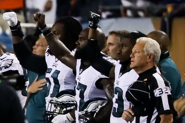 Philadelphia Eagles players hold up their right fists