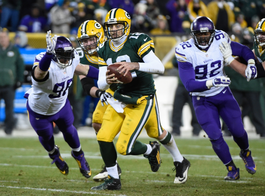 Jan 3 2016 Green Bay WI USA Green Bay Packers quarterback Aaron Rodgers scrambles away from Minnesota Vikings defensive end Brian Robison in the fourth quarter at Lambeau Field. Mandatory Credit Benny Sieu-USA TODAY Sports