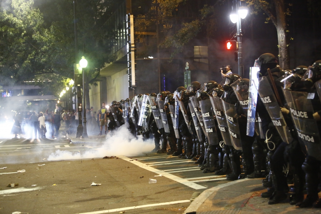 Police clash with protestors as residents and activists protest the death of Keith Scott