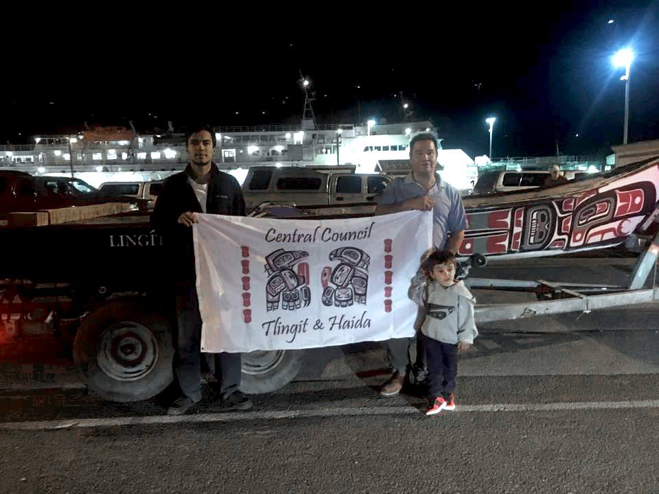 Doug Chilton and De Andre King in front of the canoe they're transporting to North Dakota