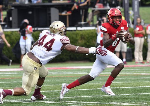 Louisville quarterback Lamar Jackson avoids the tackle form Florida State defensive end De Marcus Walker during the third quarter of an NCAA college football game Saturday Sep. 17 2016 in Louisville