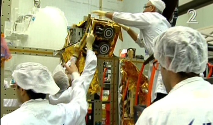 Workers for Israel Aerospace Industries building the Amos 6 satellite in footage aired