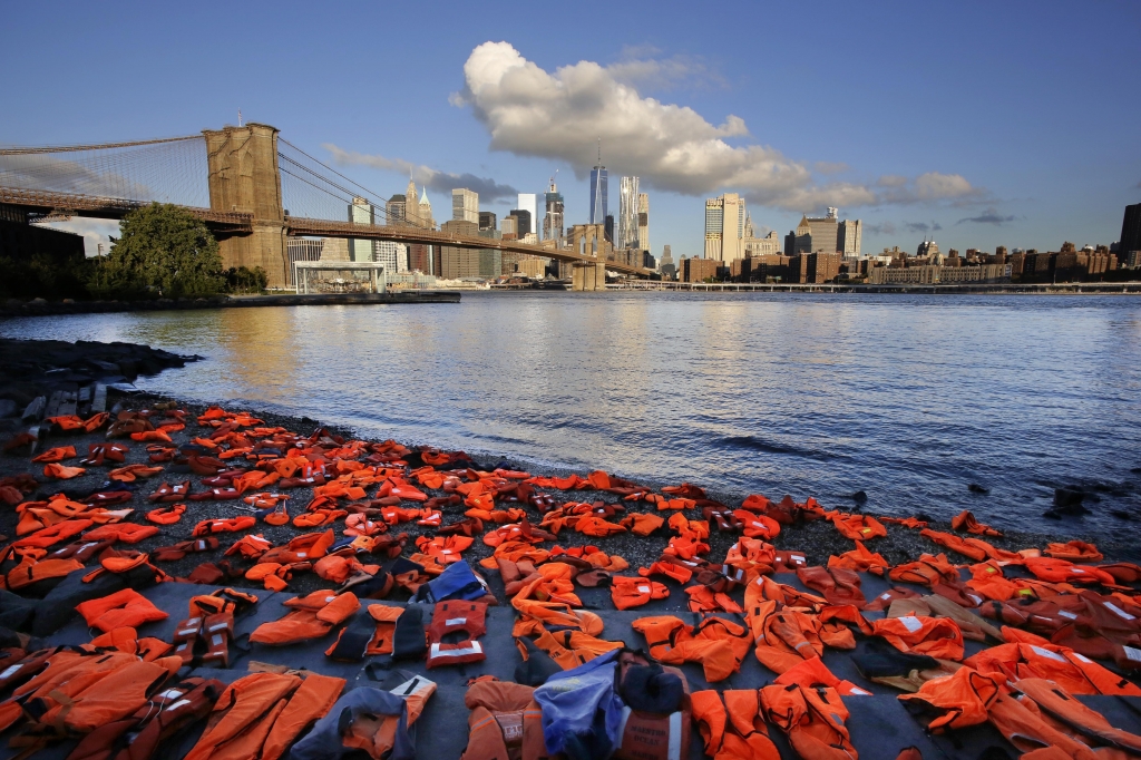 Hundreds of life jackets line the shore of the New York City waterfront on Sept. 16 placed there by advocates with Oxfam America to draw attention to the refugee crisis