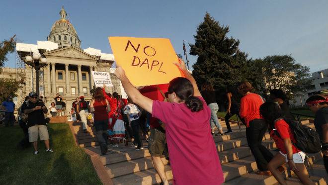 A line of protesters against the construction of the Dakota Access oil pipeline on the Standing Rock Reservation in North Dakota head to a unity rally on the west steps of the State Capitol late Thursday Sept. 8 2016 in Denver