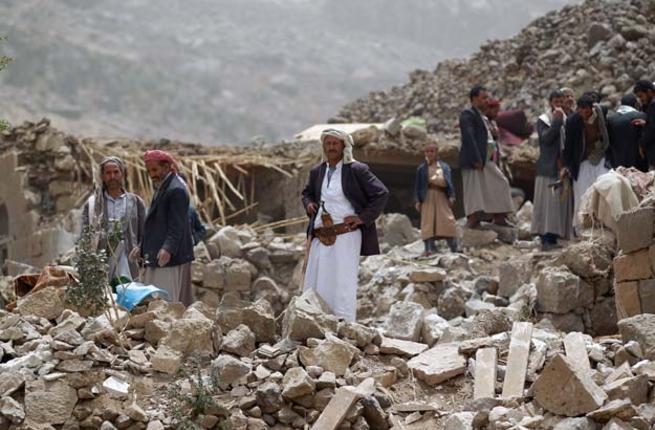 Yemeni civilians look through the rubble of their homes after an airstrike west of the capital in 2015