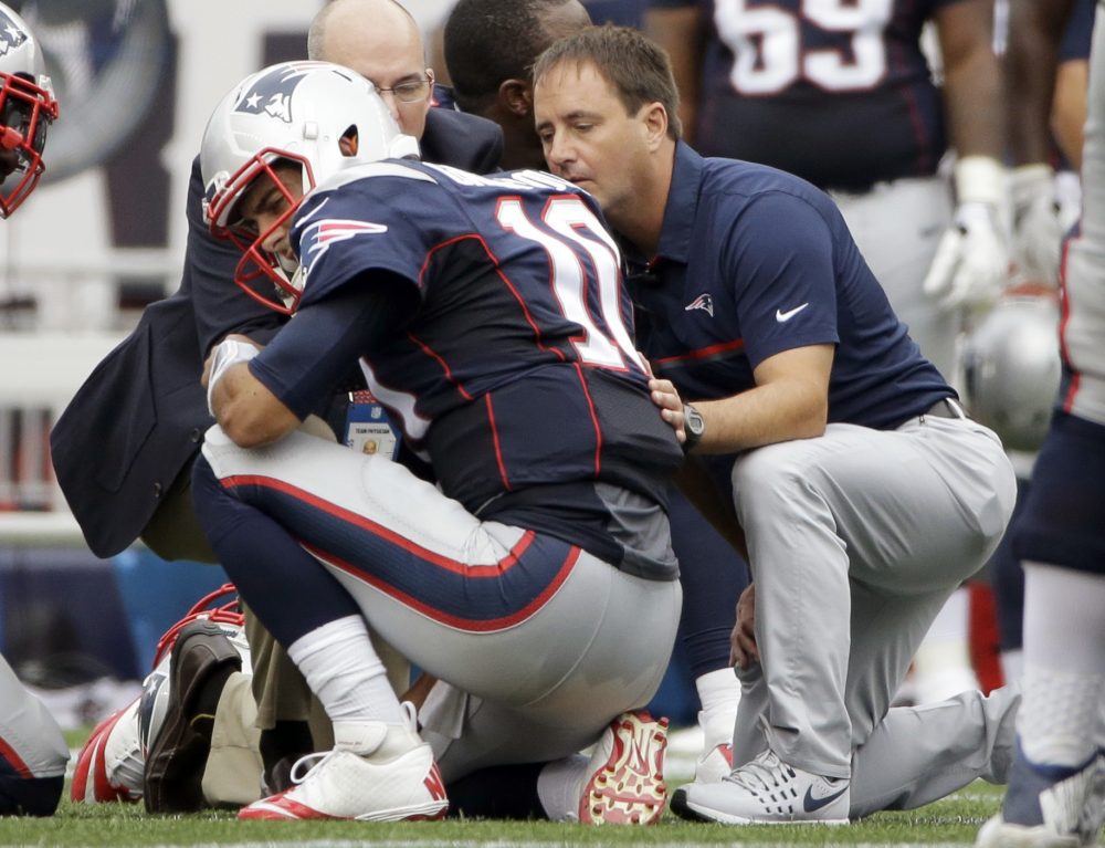 Quarterback Jimmy Garoppolo receives medical attention during the first half of Sunday's game against the Miami Dolphins