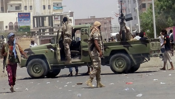 Soldiers and people gather at the site of an attack by a suicide bomber in a compound run by local militias in the southern port city of Aden Yemen Aug. 29 2016