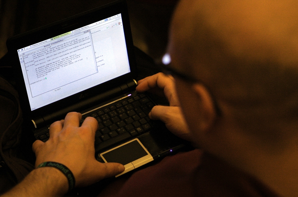 BERLIN GERMANY- DECEMBER 27 A participant looks at lines of code on a laptop on the first day of the 28th Chaos Communication Congress  Behind Enemy Lines computer hacker conference